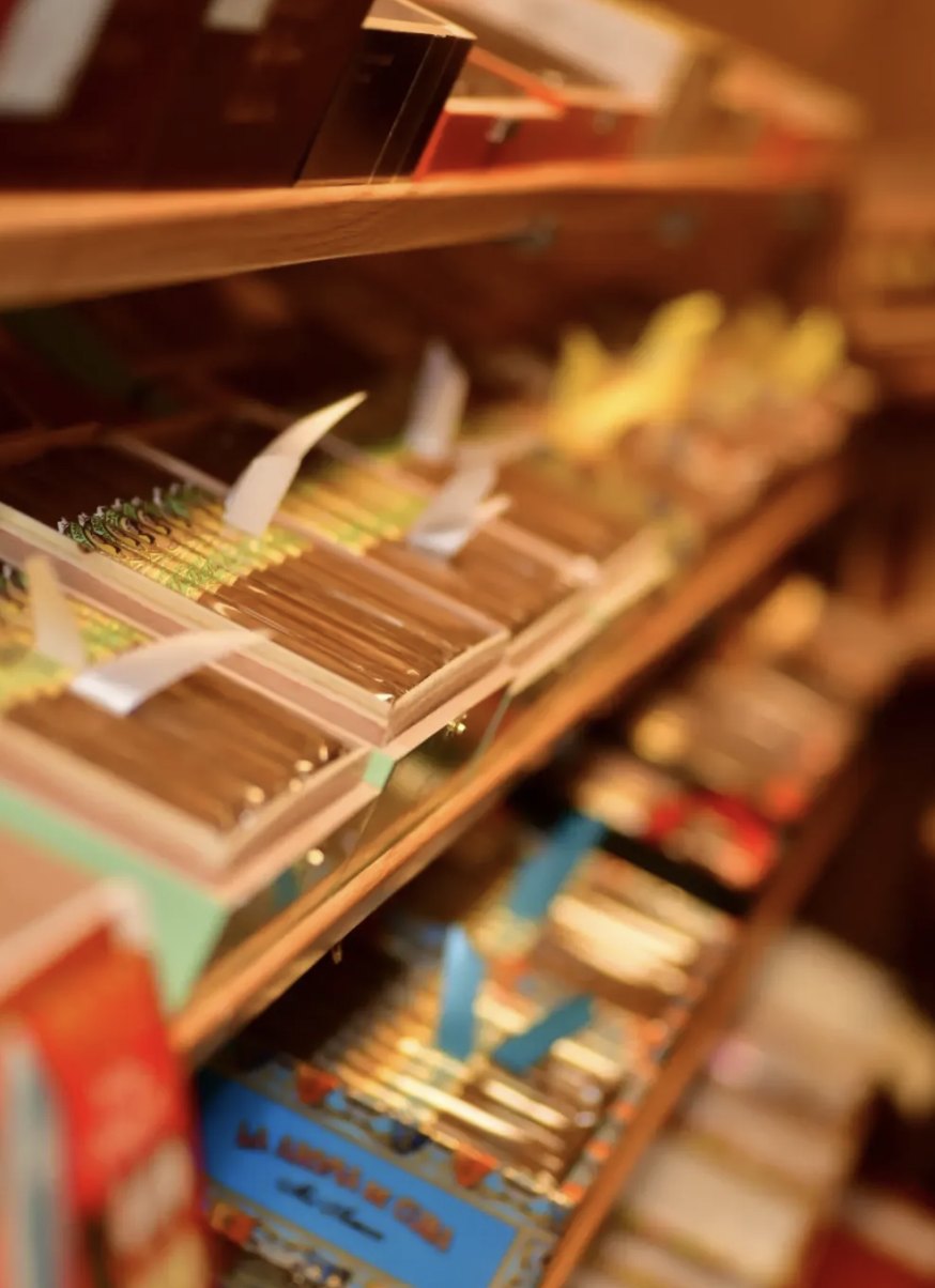 Shelves of open cigar boxes inside the humidor at Ember Premium Cigar Lounge